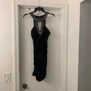 Body contour black dress. Ruffled in the right places, on the sides and back.